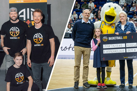 Vier Männer in Basketball AID Shirts, rechts Übergabe eines 10.000 € Schecks an die Kinderonkologie.