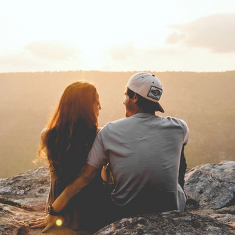 Woman and man sitting together on a rock