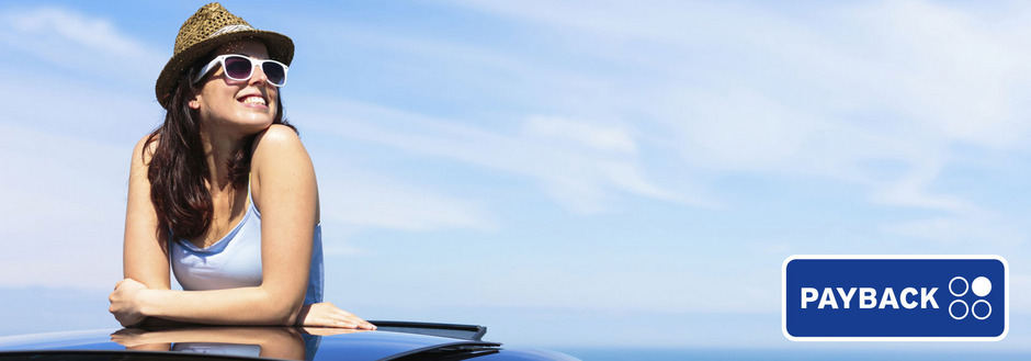 Person wearing a straw hat leaning on a car roof under a blue sky, PAYBACK logo on the right